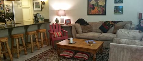 Cozy living area with a gas fireplace and great meadow and mountain views.