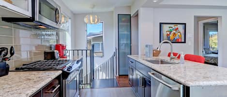 View of kitchen toward spiral staircase to downstairs