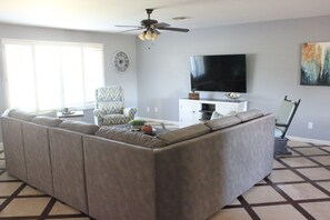 Spacious living room with plenty of seating and a 65" TV
