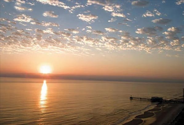 Incredible sunrise over the ocean from the balcony looking towards pier