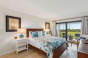 Primary bedroom with sliding doors leading to the beach and pool area.