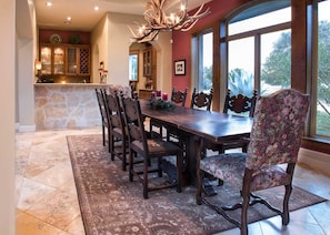 Natural light and an antler chandelier create a wonderful dining experience around a table fit for a castle!