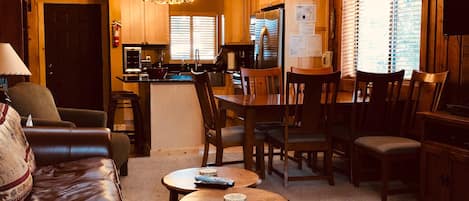 Living room with the kitchen in the background. 