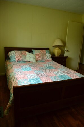 The third bedroom is located next to the bathroom and has a queen bed.