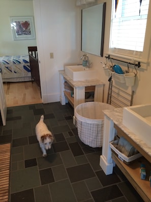 Large double vanity tub/shower combo bath with cool slate floor.