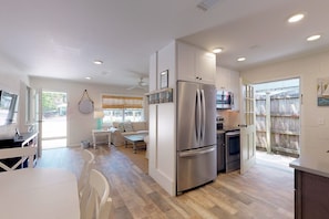 Open floor plan with dining area off kitchen which flows into living area.