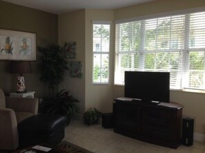 Living room looking out windows overlooking park