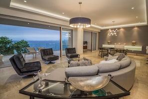 Living Room Glass Doors Open to Spacious Private Terrace. Beachfront View.