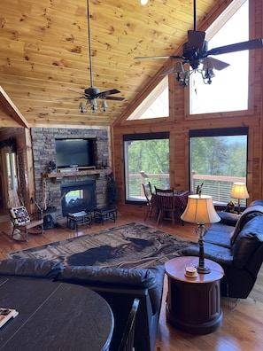 Spacious gathering room with fireplace, view, books, games, streaming 
TV.