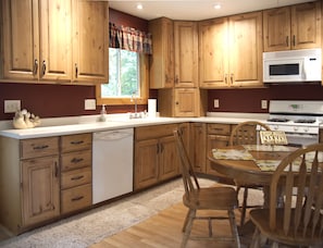 Full-size appliances including a dishwasher, coffee maker, microwave, & toaster