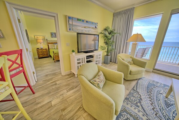 Great room with 60 in HDTV, HD-DVR,  and two swivel chairs.