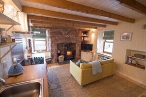 The sitting room and kitchen with wood burning stove