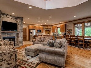 Working gas fireplace looking into the kitchen and dining room