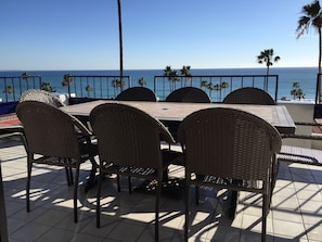 Top Floor patio has ocean view, table &  chairs for 12, chaise lounges & BBQ.