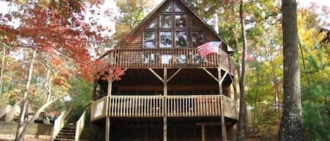 House lakeside with two decks, screened porch and hot tub.