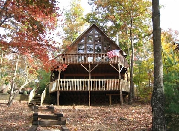 House lakeside with two decks, screened porch and hot tub.