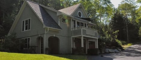 Front corner view of the Carriage House shows off the deck and entry portico.