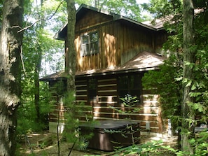 Back view of cabin where the hot tub is, up top is the den/4th bedroom
