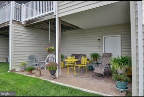 patio and grass area for cornhole