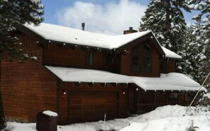 Entrance to our home with front deck, 2 car garage & additional parking in front