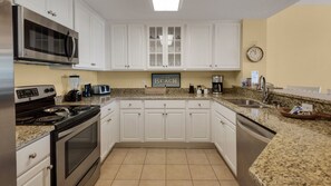 Fully equipped kitchen with new stainless appliances, cabinets and countertops