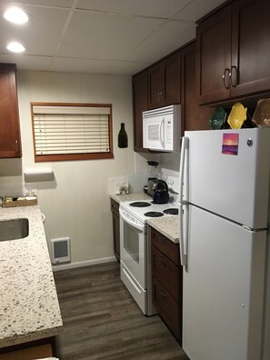 Remodeled kitchen with quartz countertops and new appliances