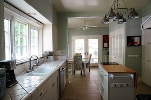 Sunny kitchen with access to courtyard and washer and dryer.