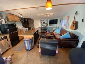 Living area has a vaulted ceiling, 50 inch TV with Cable, Apple TV, and DVD.