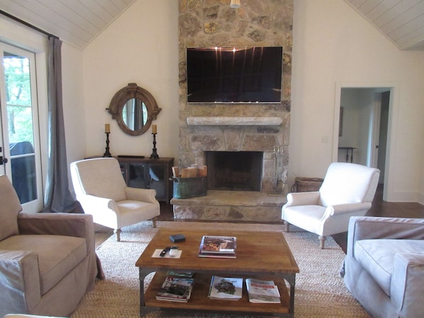 Living room with stone fireplace with gas starter.