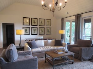 Spacious living room with vaulted ceiling, fireplace and view.