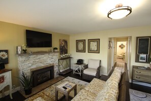 Living room, with Samsung SmartHub (internet-enabled) TV, & hall to bedrooms.