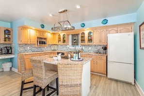 Fully stocked kitchen with new countertops, stove/oven and coffee bar