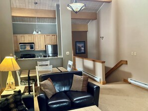 Living Room with view to Kitchen, Dining Space and stairs to lower level