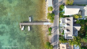 Overhead view of The Blue Dolphin, private dock, and bay..