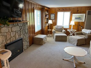 Family room with 2 Pottery Barn chairs and 3 foot stools.