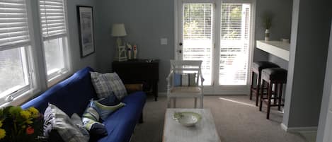 Living room with many windows and vaulted ceiling