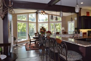 Wrap around bar for seven and view of dining room.