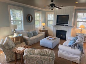 Spacious living area with plenty of seating for everyone.  Two couches and chairs make this the perfect place to relax after exploring the beach.  Cable TV and DVD (with vast library).  Gas fireplace is operated by the thermostat on the wall by the stairs.