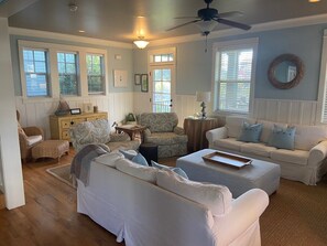 Spacious living area with plenty of seating for everyone.  Two couches and chairs make this the perfect place to relax after exploring the beach.  Cable TV and DVD (with vast library).  Gas fireplace is operated by the thermostat on the wall by the stairs.