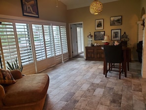 Arizona room with wooden blinds to backyard, and door to master BR.