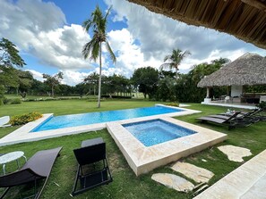 Jacuzzi and pool, with view of Romana Country Club golf course on the background