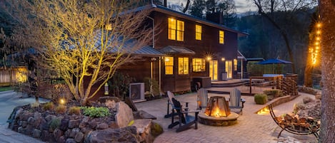 Creekside back patio and deck with fire pit, outdoor seating, dining and hot tub