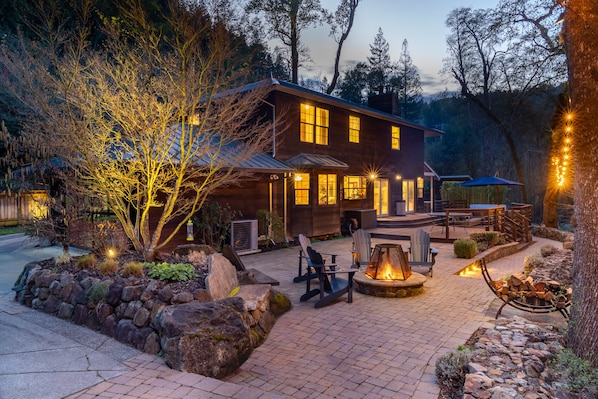 Creekside back patio and deck with fire pit, outdoor seating, dining and hot tub