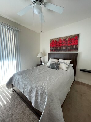 Spacious and bright bedroom with access to patio. 