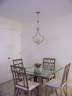 Dining Area. Table seats four. Portable baby seat in master closet.