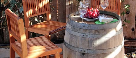 Enjoy a glass of wine at the wine barrel bar under shaded arbor.