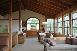 Great room facing the dining area. Wall of windows facing the bay to the right