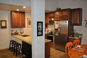 Modern style galley kitchen open to living and dining area