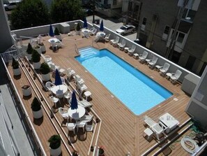 Plenty of tables and chairs for relaxing by the pool