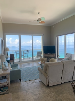 Watch TV, paragliders, or pelicans fly by in the inviting living area.